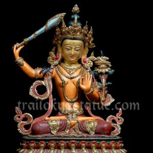 Colored Manjushri holding a flaming sword of wisdom and a scripture